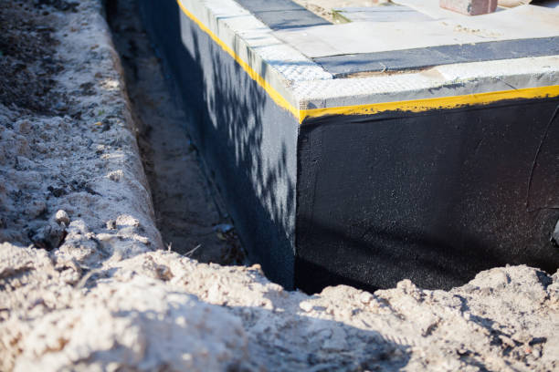 Professional Basement Waterproofing technician working in Lake George, MI